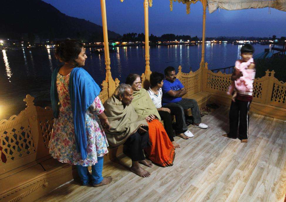 Indian tourists enjoy an evening on the deck of a houseboat in Srinagar. (REUTERS/Fayaz Kabli/Files)