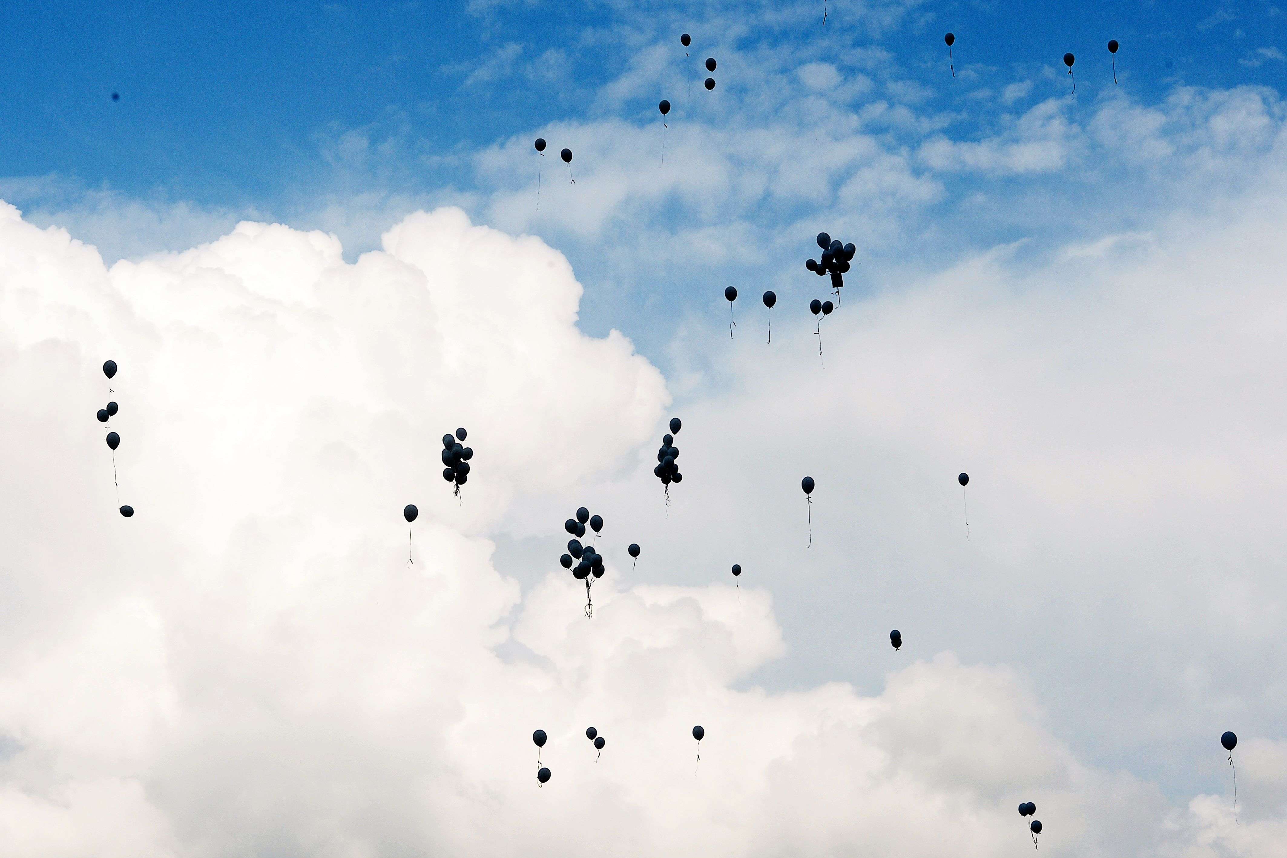 Family members and relatives of the victims of the crash of the Germanwings plane throw 149 white balloons during a ceremony in Le Vernet, southern France. An inter-religious service will be held today in honour of the victims of the Germanwings crash over the French Alps, including the burial of some of the remains that haven't yet been identified. (AFP/Boris Horvat) 