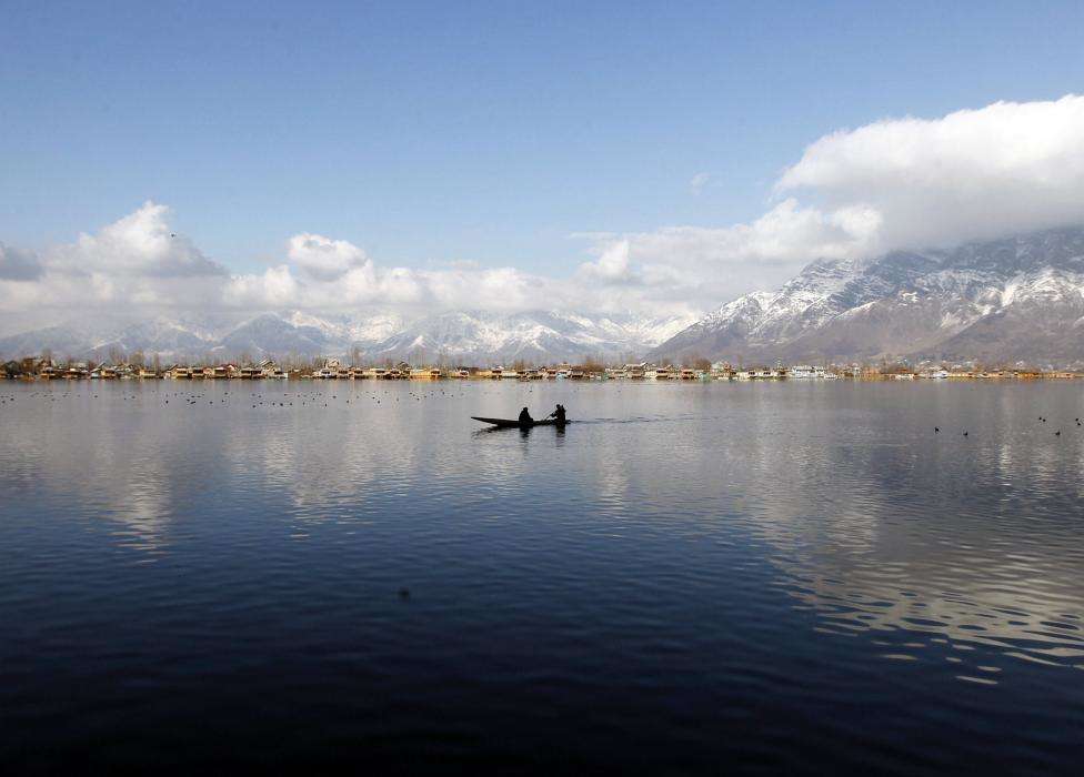 A man rows a small boat on the waters of Dal Lake on a sunny day in Srinagar. (REUTERS/Danish Ismail/Files)