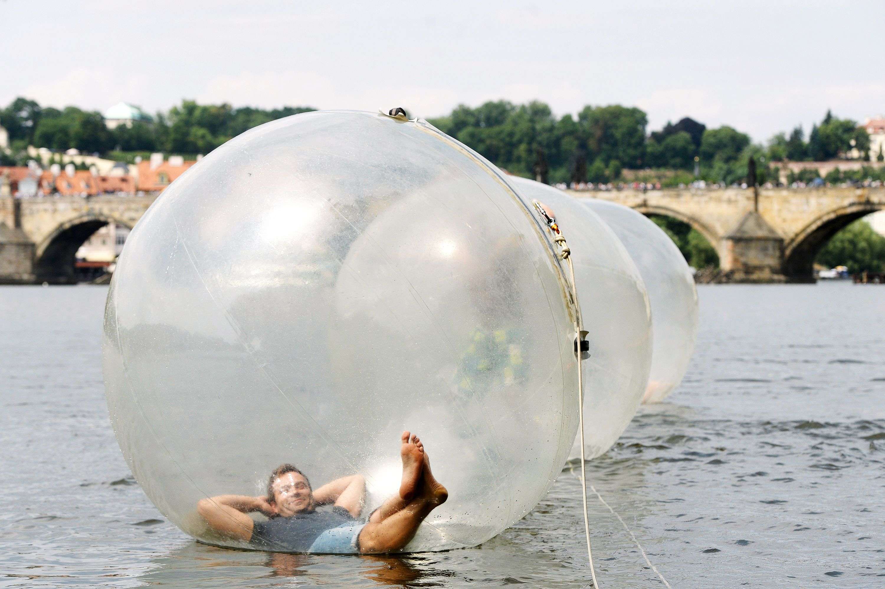 Tourists play in zorb balls on the Vltava river as temperatures reached 34 degrees Celsius in Prague, Czech Republic. (AFP/ Michal Cizek) 