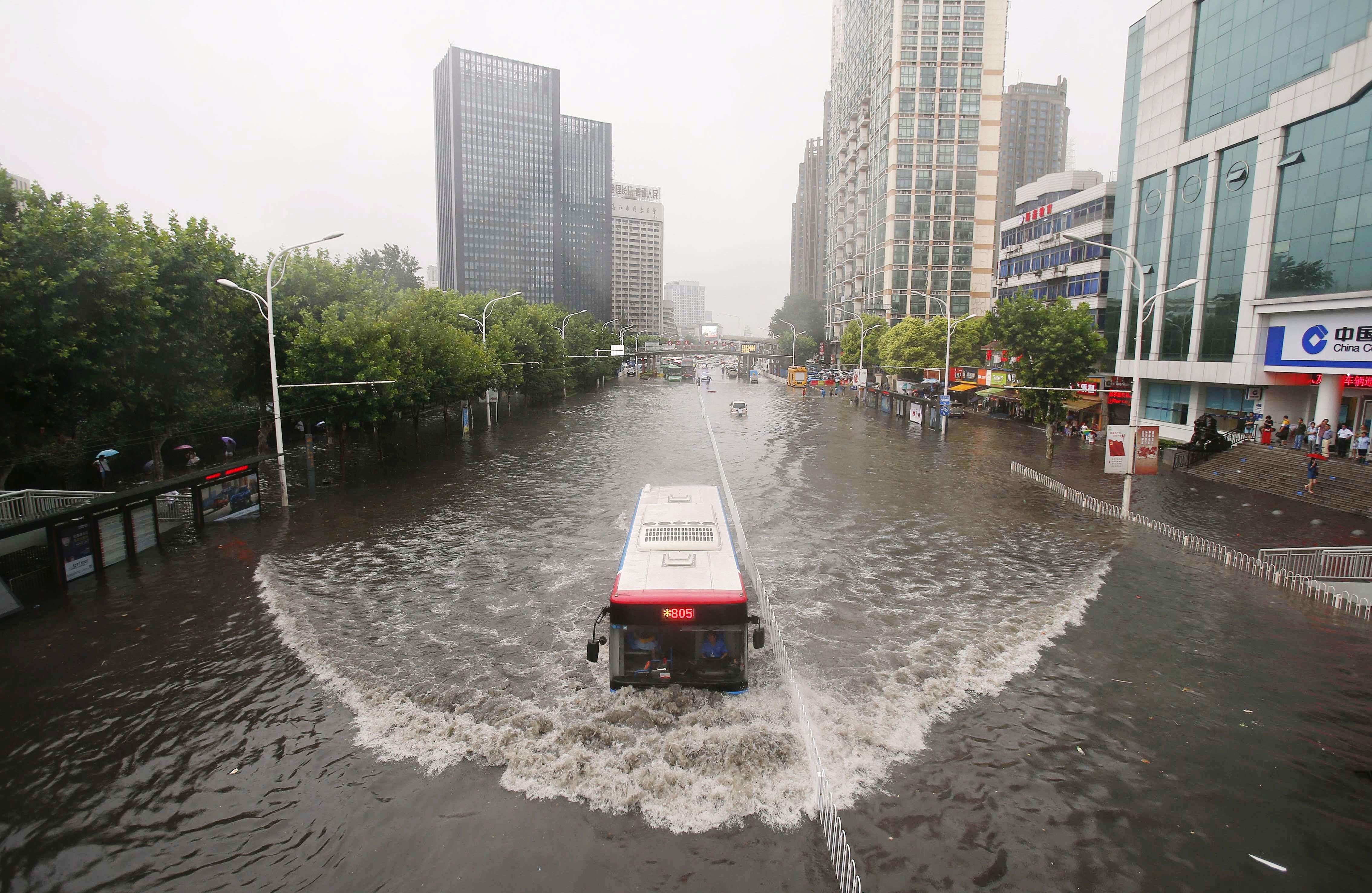 A bus making its way through floodwaters in Wuhan, in central China's Hubei province, as strong storms hit central and eastern China. (AFP) 