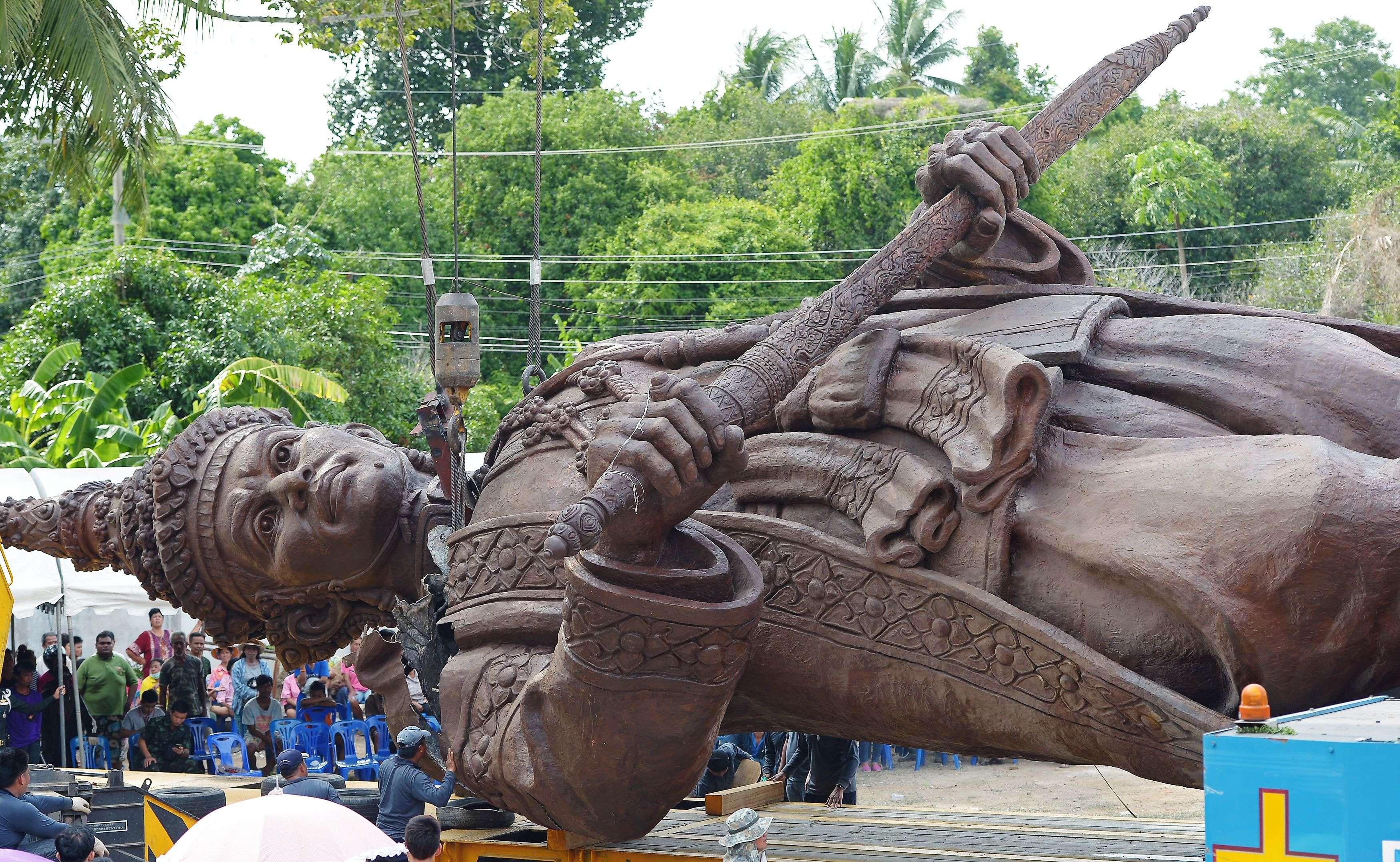 Thai workers and soldiers prepare a statue of King Narai of Ayutthaya for transport from a casting factory in Lopburi province. The statue will be part of an installation at a park called Ratchapakdi in Hua Hin to honour past Thai monarchs. The park, under construction by the Thai army, honour's the country's royal institution and is located at a military compound near the Klai Kangwon Palace. (AFP/Pornchai Kittiwongsakul) 