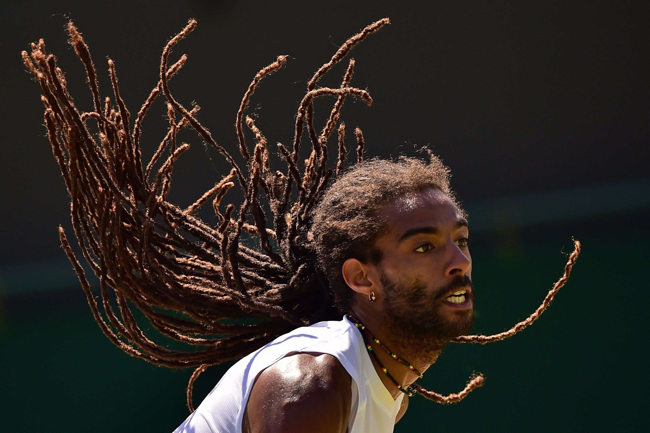 Germany's Dustin Brown waits to receive a serve from Serbia's Viktor Troicki during their men's singles third round match on day six of the 2015 Wimbledon Championships at The All England Tennis Club in Wimbledon, southwest London. (AFP PHOTO / LEON NEAL)