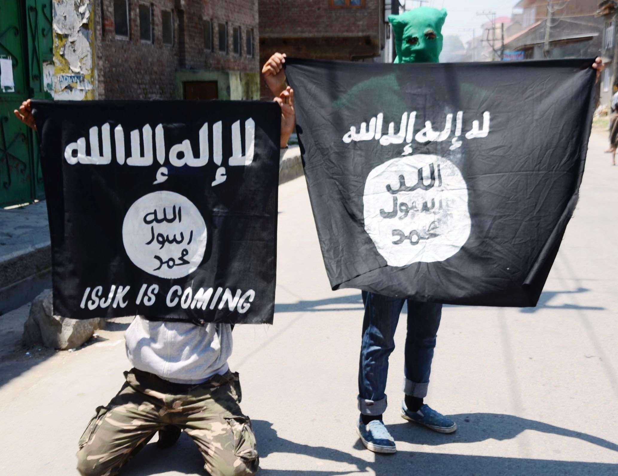 Youths displaying the flags of ISIS at Gojiwara in down town Srinagar as Kashmir valley observed a shut down on a call given by Hurriyat Conference (M) on Saturday against alleged forcible entry of security forces into historic Jamia masjid premises after Friday prayers PHOTO BY BILAL BAHADUR