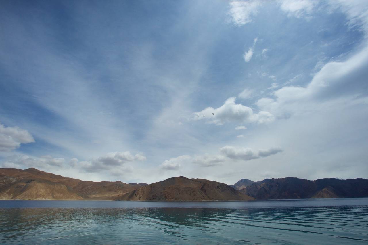 This Blue drives away your blues: If you are lucky, you see multiple hues of blue in Pangong Lake. Do spend some time and look at it from different vantage points. If you start early for Pangong Se (lake), you will reach at the time when clouds are just building up over it. And that makes a lot of difference to its beauty
