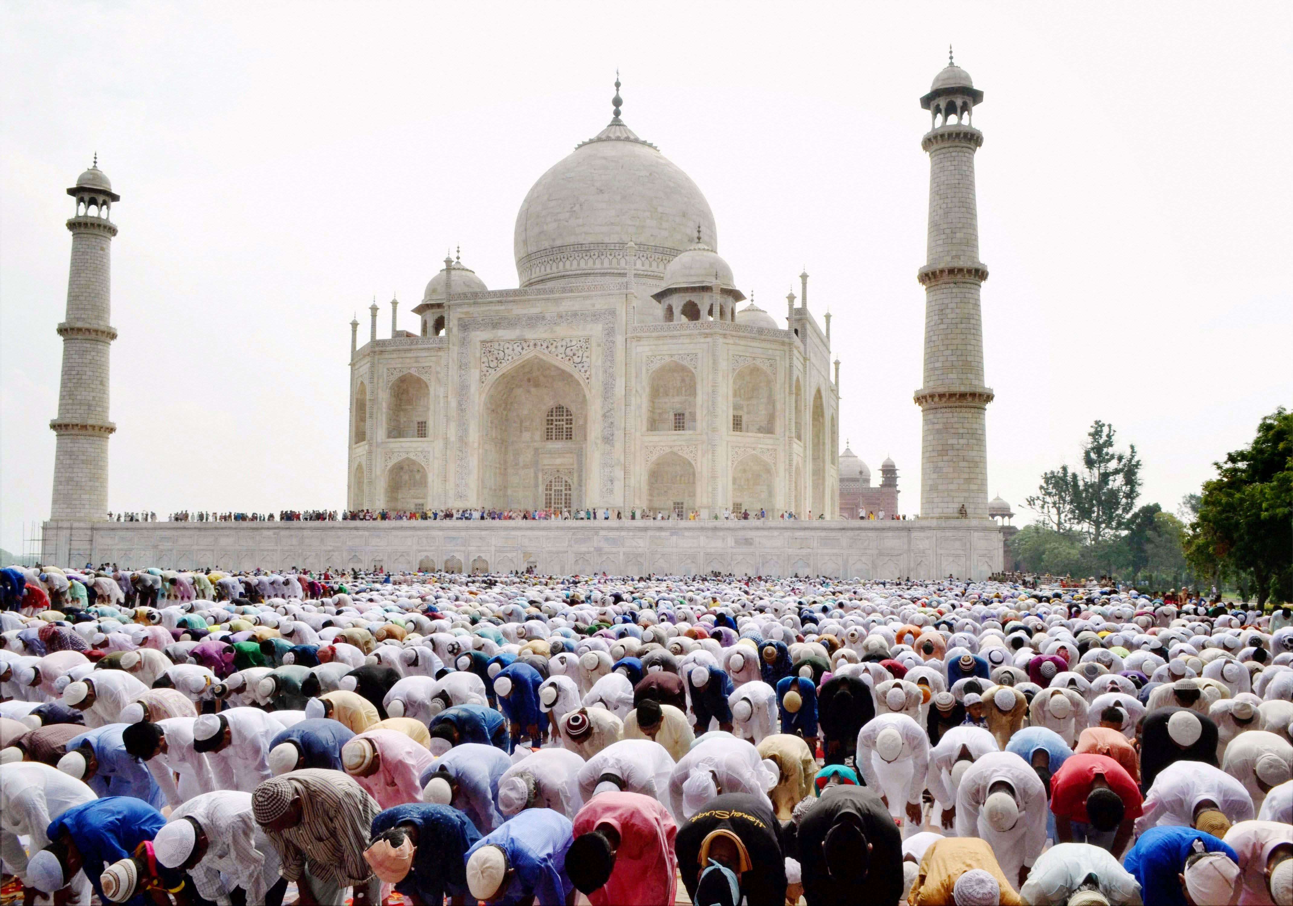 Muslims offer prayers in the premises of the Taj Mahal in Agra, India on the occasion of Eid-ul-Fitr. (PTI)