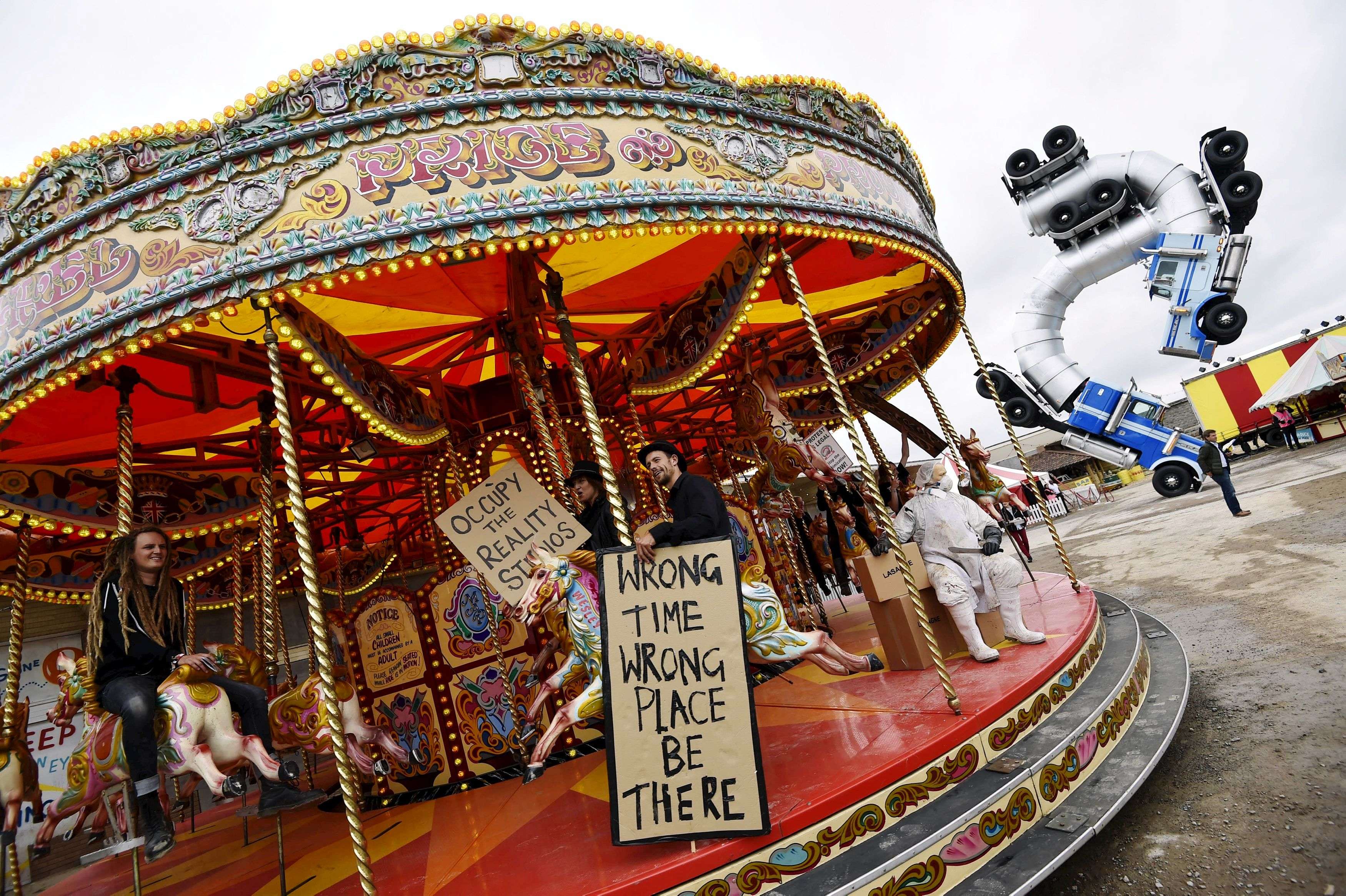 People ride a carousel at 'Dismaland', a theme park-styled art installation by British artist Banksy, at Weston-Super-Mare in southwest England, Britain, August 20, 2015. REUTERS/Toby Melville