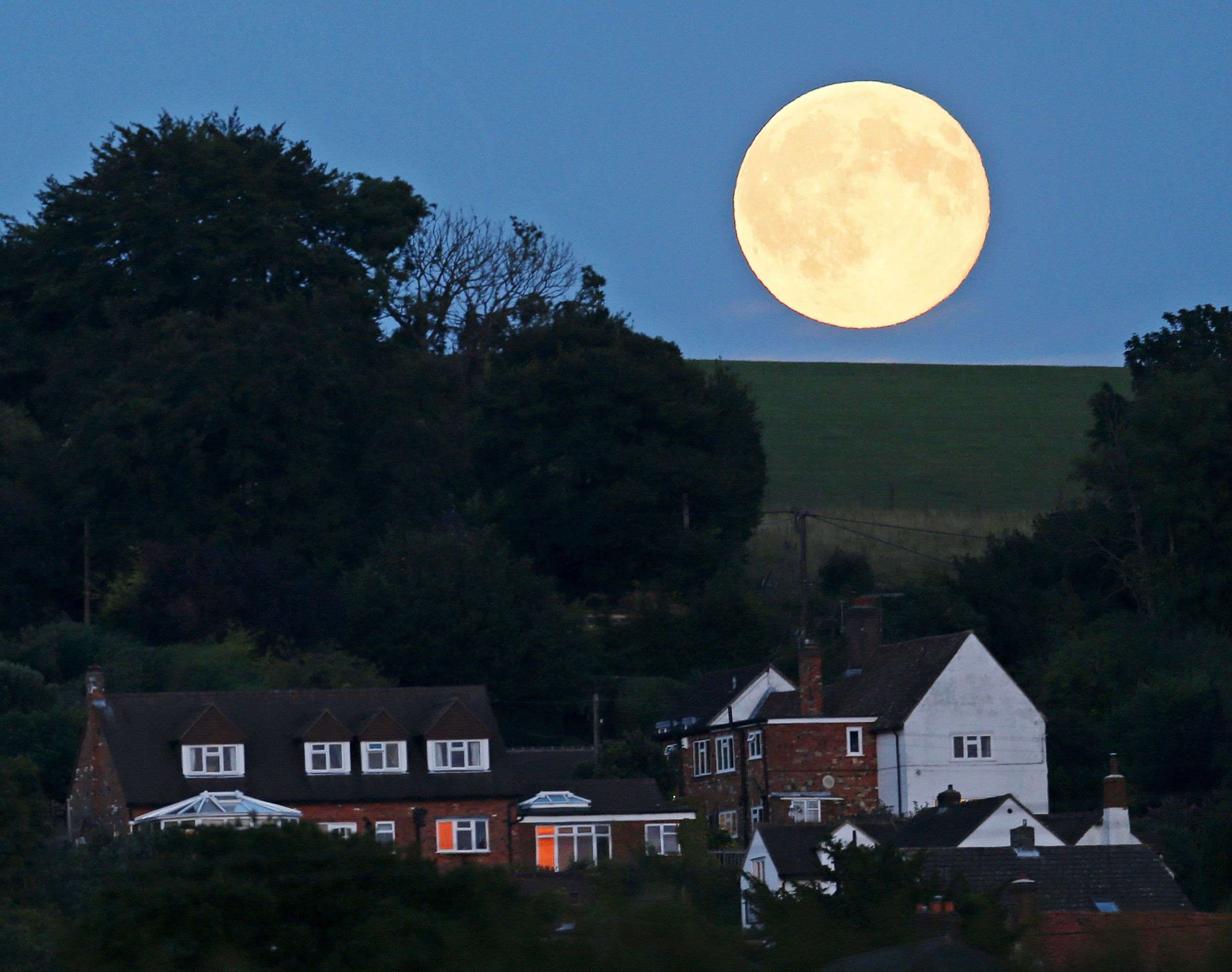 A full moon, known as the Blue Moon is seen over Loosely Row, near Princes Risborough, southeast England, July 31, 2015. REUTERS/Eddie Keogh