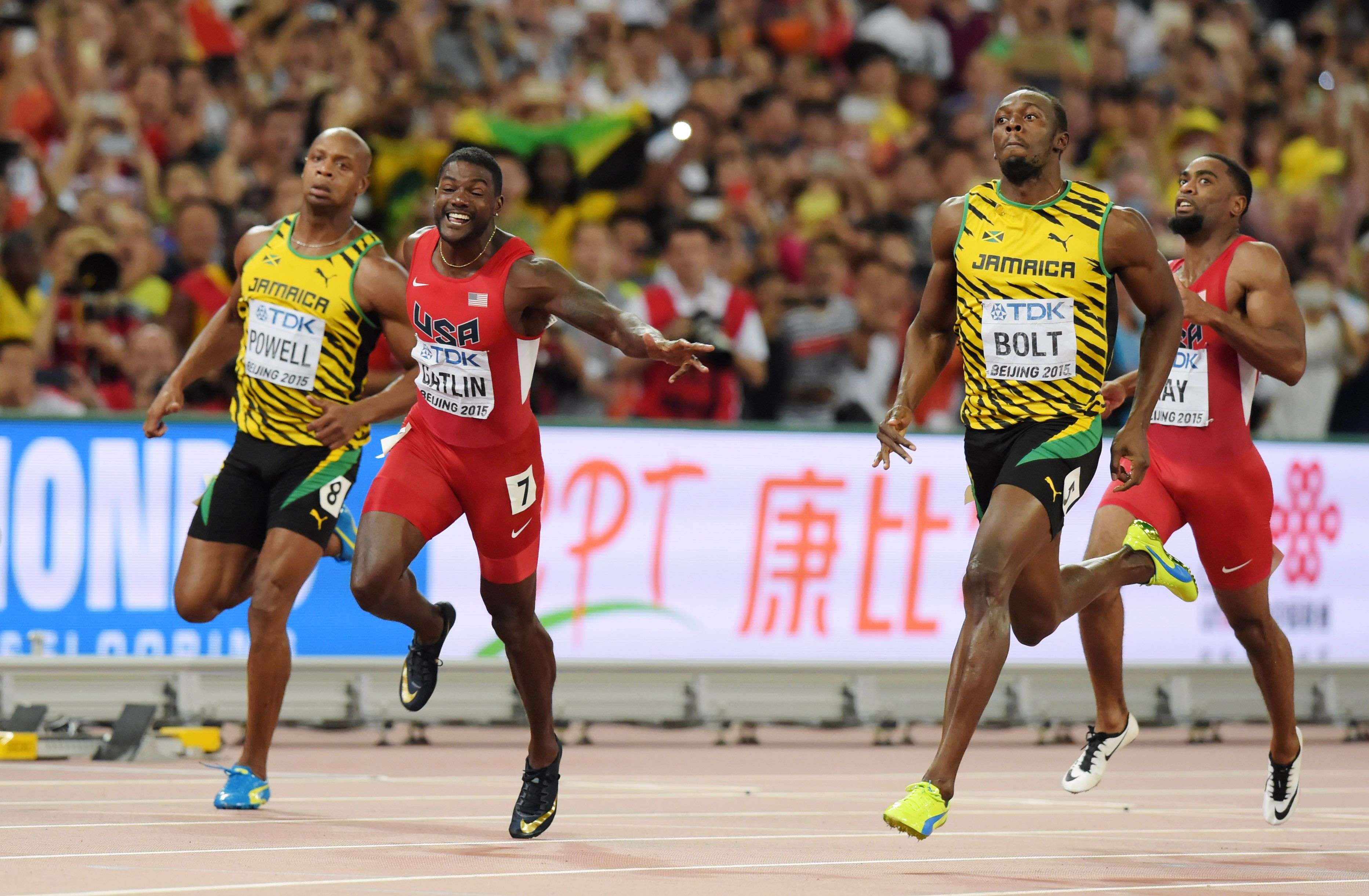 Aug 23, 2015; Beijing, China; Usain Bolt (JAM) reacts after defeating Justin Gatlin (USA) to win the 100m in 9.79 to 9.80 during the IAAF World Championships in Athletics at National Stadium. From left: Asafa Powell (JAM), Gatlin, Bolt and Tyson Gay (USA). Mandatory Credit: Kirby Lee-USA TODAY Sports