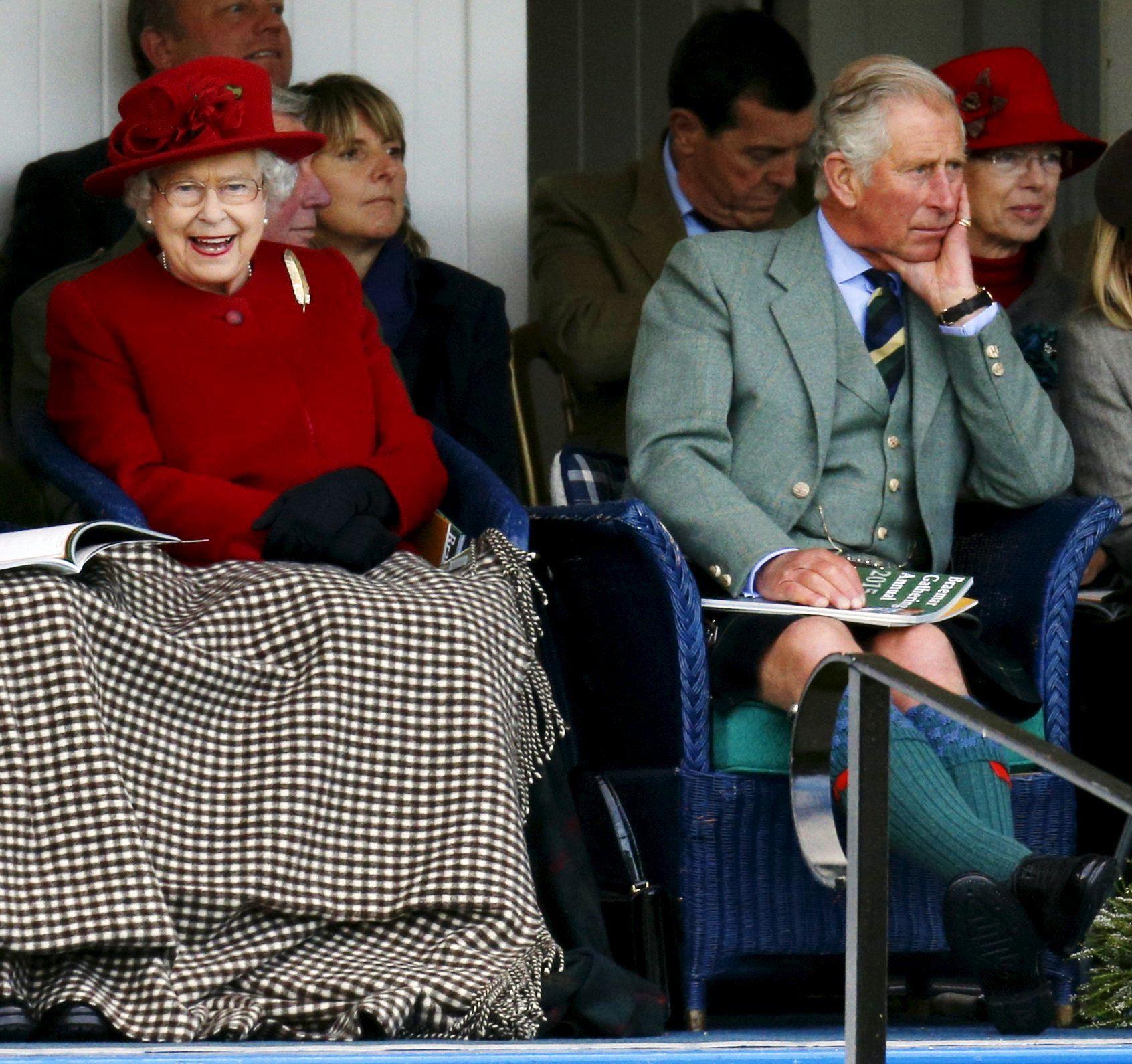 Britain's Queen Elizabeth and Prince Charles watch the sack race at the annual Braemar Highland Gathering in Braemar, Scotland, Britain September 5, 2015. Queen Elizabeth will become Britain's longest-ever serving monarch on September 9. REUTERS/Russell Cheyne