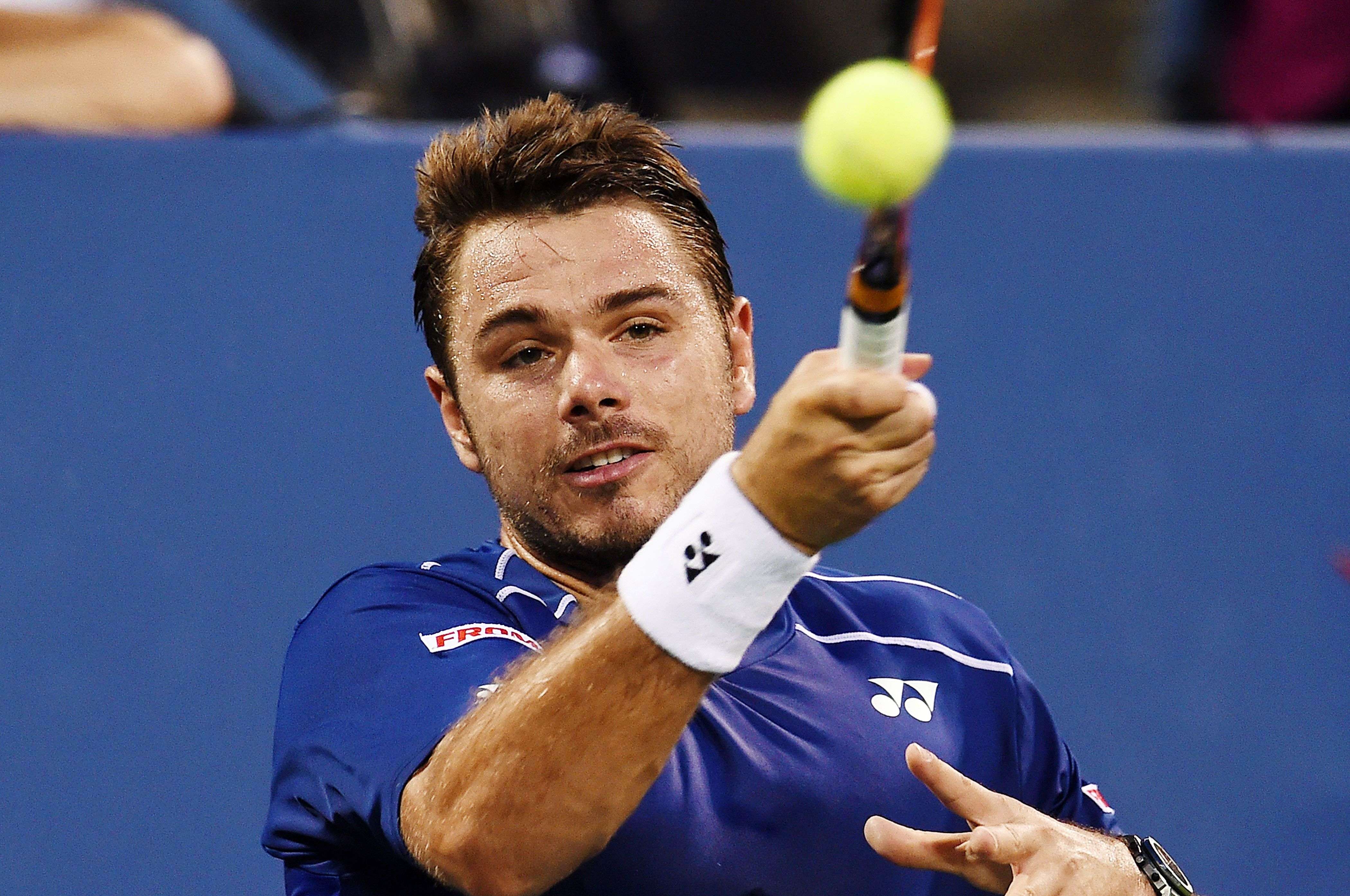 Stan Wawrinka of Switzerland returns the ball to Kevin Anderson of South Africa during their 2015 US Open Men's singles quarterfinals match at the USTA Billie Jean King National Tennis Center in New York on September 9, 2015. Wawrinka won 6-4, 6-4, 6-0. AFP PHOTO/JEWEL SAMAD