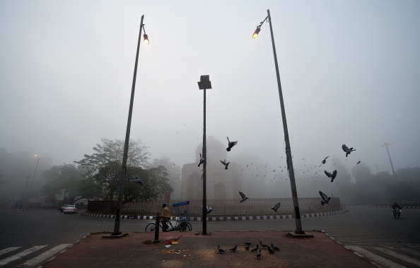 Pigeons fly above the Nila Gumbad (Blue Domed tomb) part of the Humayun's Tomb complex on a foggy morning in New Delhi on January 18, 2012. Cold wave conditions continued across North India claiming 165 lives this winter. AFP PHOTO/ Manan VATSYAYANA (Photo credit should read MANAN VATSYAYANA/AFP/Getty Images)