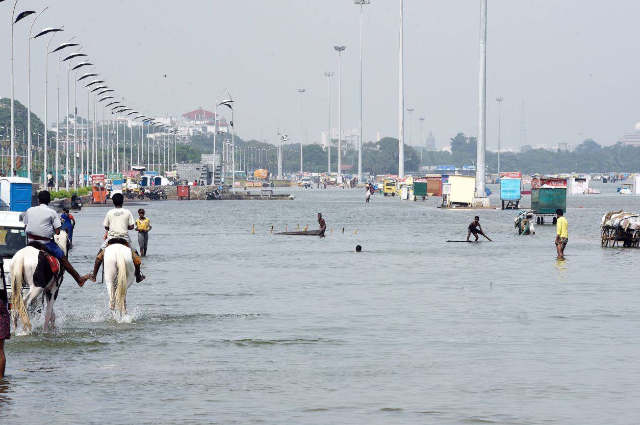 People playing on the Marina beach service road flooded with sea water on the Bay of Bengal. (Photo courtesy: B A Raju)