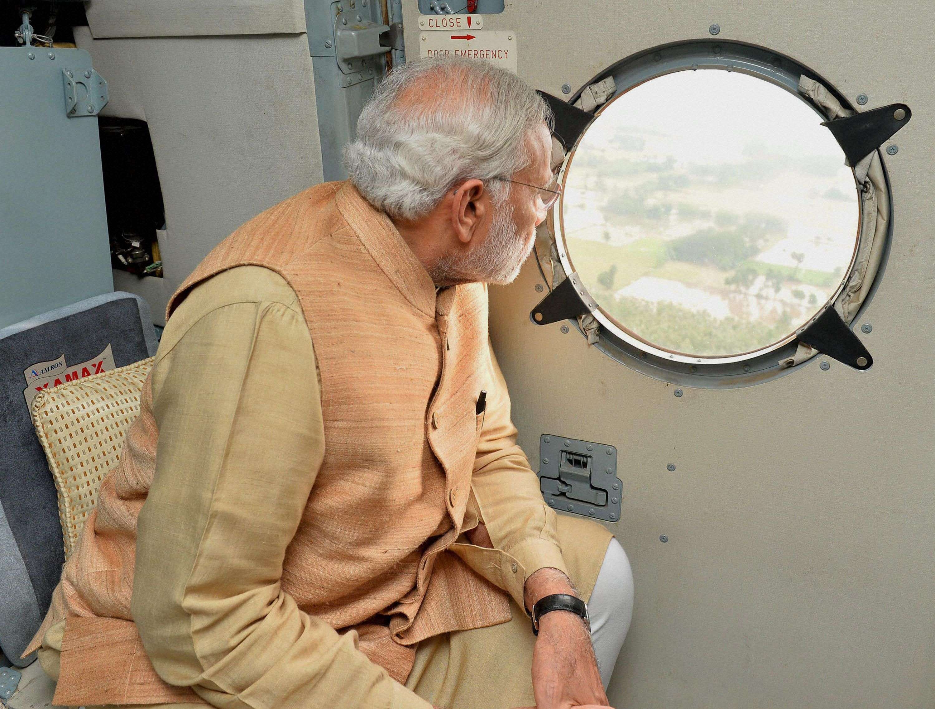 Chennai: Prime Minister Narendra Modi conducting an aerial survey of rain hit areas of Chennai, Tamil Nadu on Thursday. PTI Photo / PIB (PTI12_3_2015_000216B)