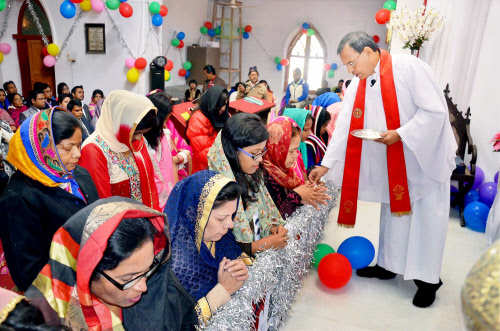 People take holy communion during mass prayer in Mirzapur  (Photo Courtesy: PTI)