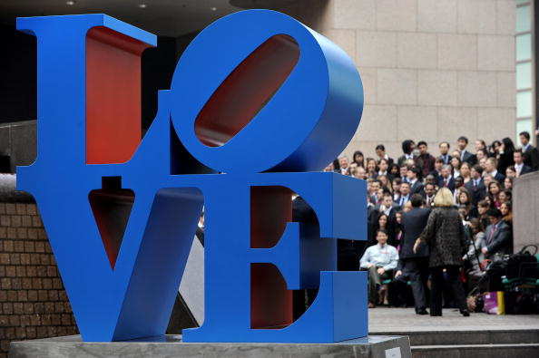 A sculpture by US artist Robert Indiana is displayed in a public area in Hong Kong on March 9, 2008 as people (background) gather for a group photo.  The sculpture is inspired from Indiana's "Love" painting from the 1960s.  AFP PHOTO/PHILIPPE LOPEZ (Photo credit should read PHILIPPE LOPEZ/AFP/Getty Images)