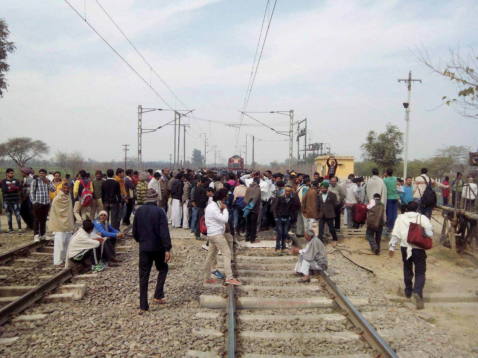 Rohtak: Jat community members block the railway tracks during their agitation for reservation near Rohtak on Monday. PTI Photo (PTI2_15_2016_000297B)
