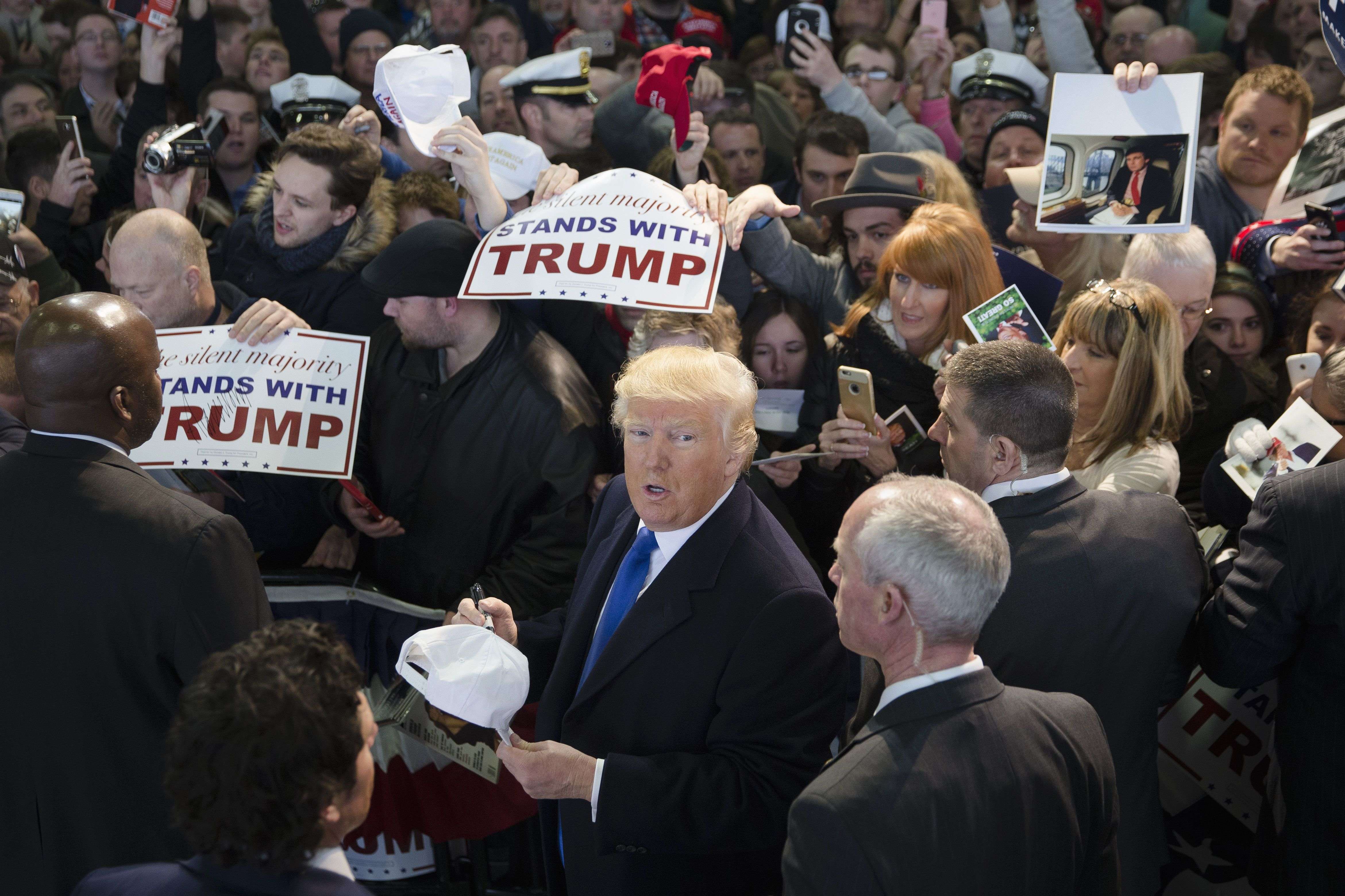 Republican presidential candidate Donald Trump signs autographs during a campaign stop at the Signature Flight Hangar at Port-Columbus International Airport, Tuesday, March 1, 2016, in Columbus, Ohio. (AP Photo/John Minchillo)