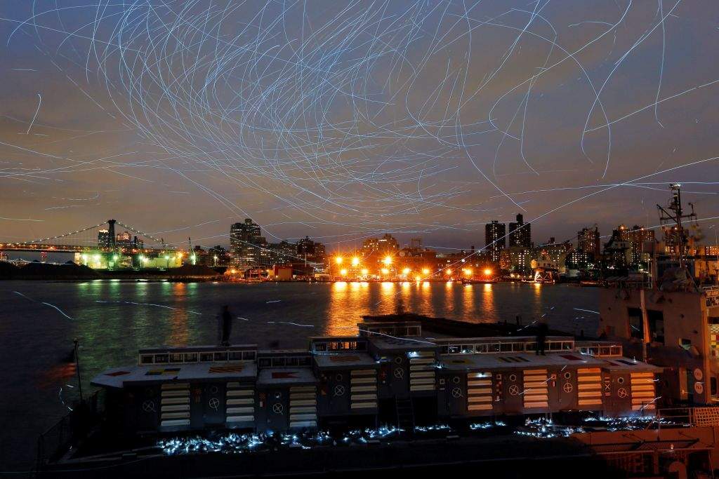 LED lights attached to pigeons leave light trails in the sky while they fly as part of the "Fly By Night" art installation by Duke Riley above the Brooklyn borough of New York, U.S.,May 5, 2016. REUTERS/Lucas Jackson