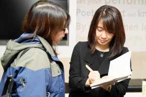 Korean author Han Kang signs a copy of her book (AFP)