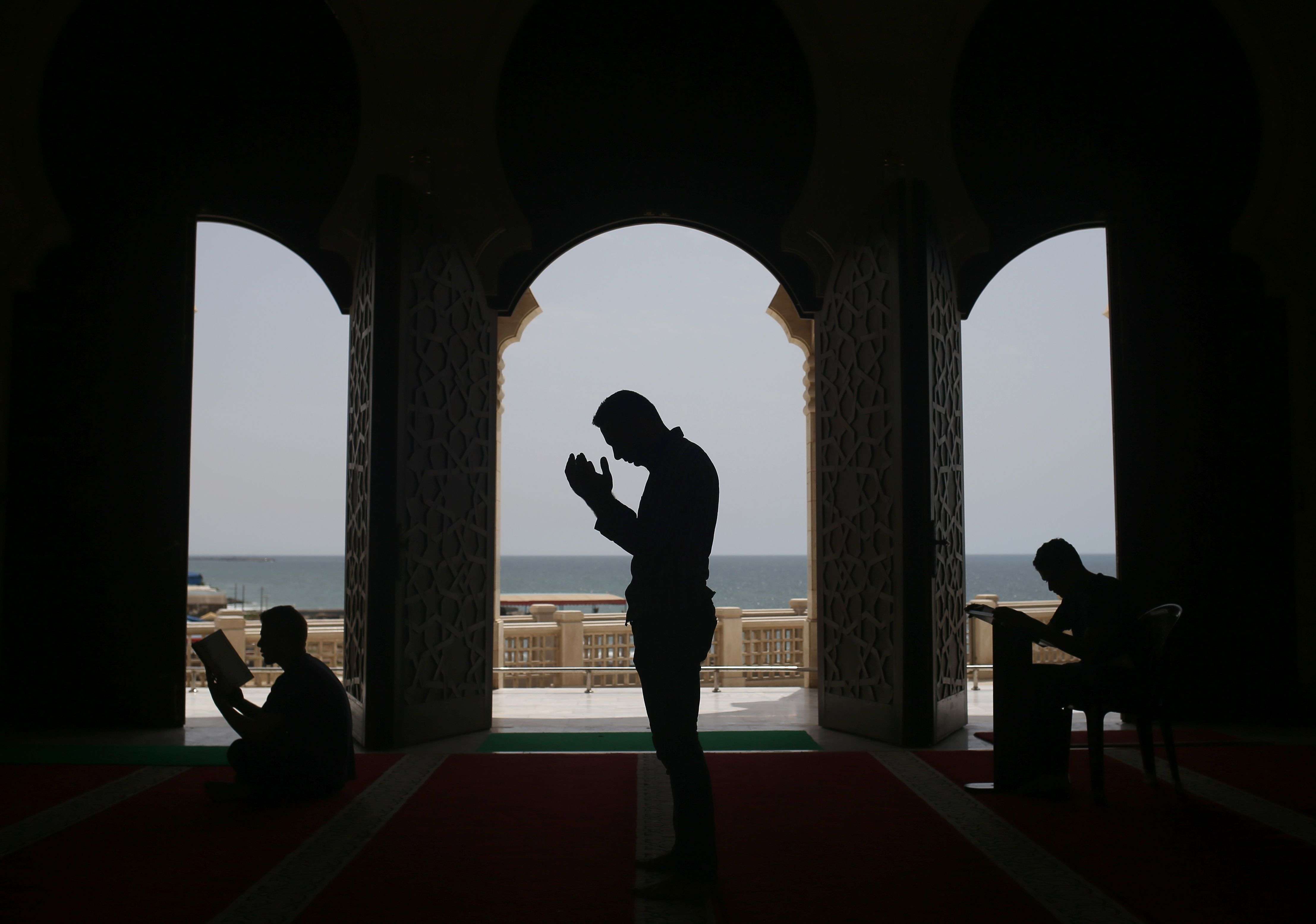 Palestinians pray at the al-Khaldi mosque in Gaza City on June 8, 2016 on the third day of the Muslim holy month of Ramadan.  Islamic authorities across much of the world -- from the most populous Muslim-majority country Indonesia to Saudi Arabia, home to the faith's holiest sites -- announced the start of the fasting month with the sighting of the crescent moon. Marking the divine revelation received by Islam's Prophet Mohammed, the month sees Muslim faithful abstain from eating, drinking, smoking and having sex from dawn to dusk. / AFP PHOTO / MOHAMMED ABED