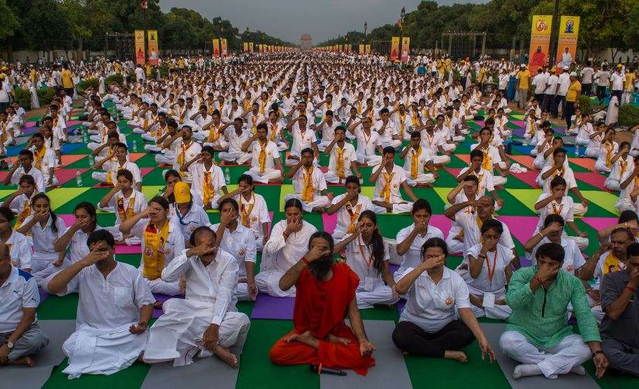 Indian yoga guru Ramdev (C) participates in a rehearsal for International Yoga Day on Rajpath in New Delhi  (Photo courtesy:  AFP/ Chandan Khanna)