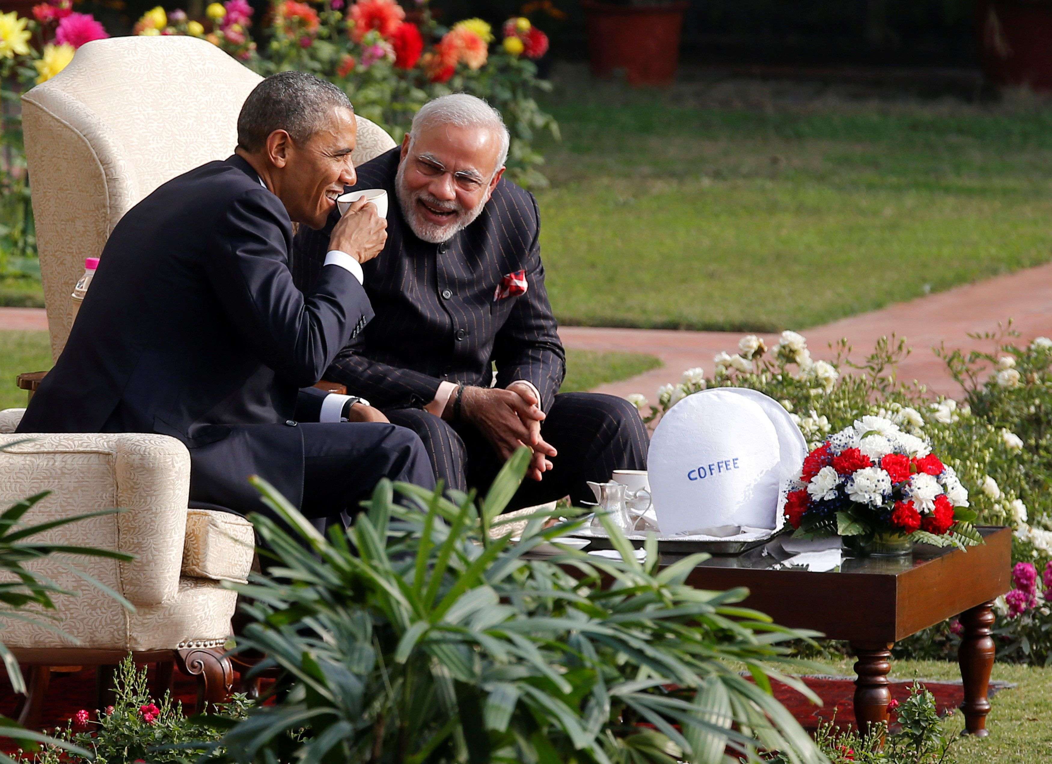 U.S. President Obama and India's PM Modi talk as they have coffee and tea together in the gardens at Hyderabad House in New Delhi
