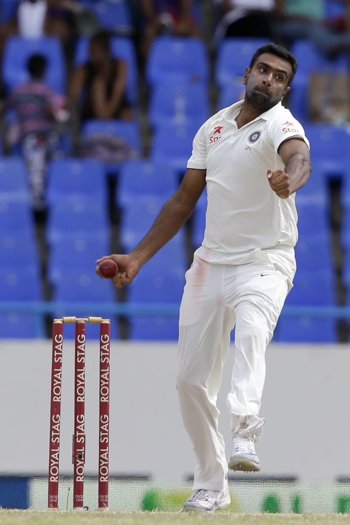 India's Ravichandran Ashwin bowls against West Indies during day four of their first cricket Test match at the Sir Vivian Richards Stadium in North Sound, Antigua, Sunday, July 24, 2016. Ashwin took seven wickets. (AP Photo/Ricardo Mazalan)