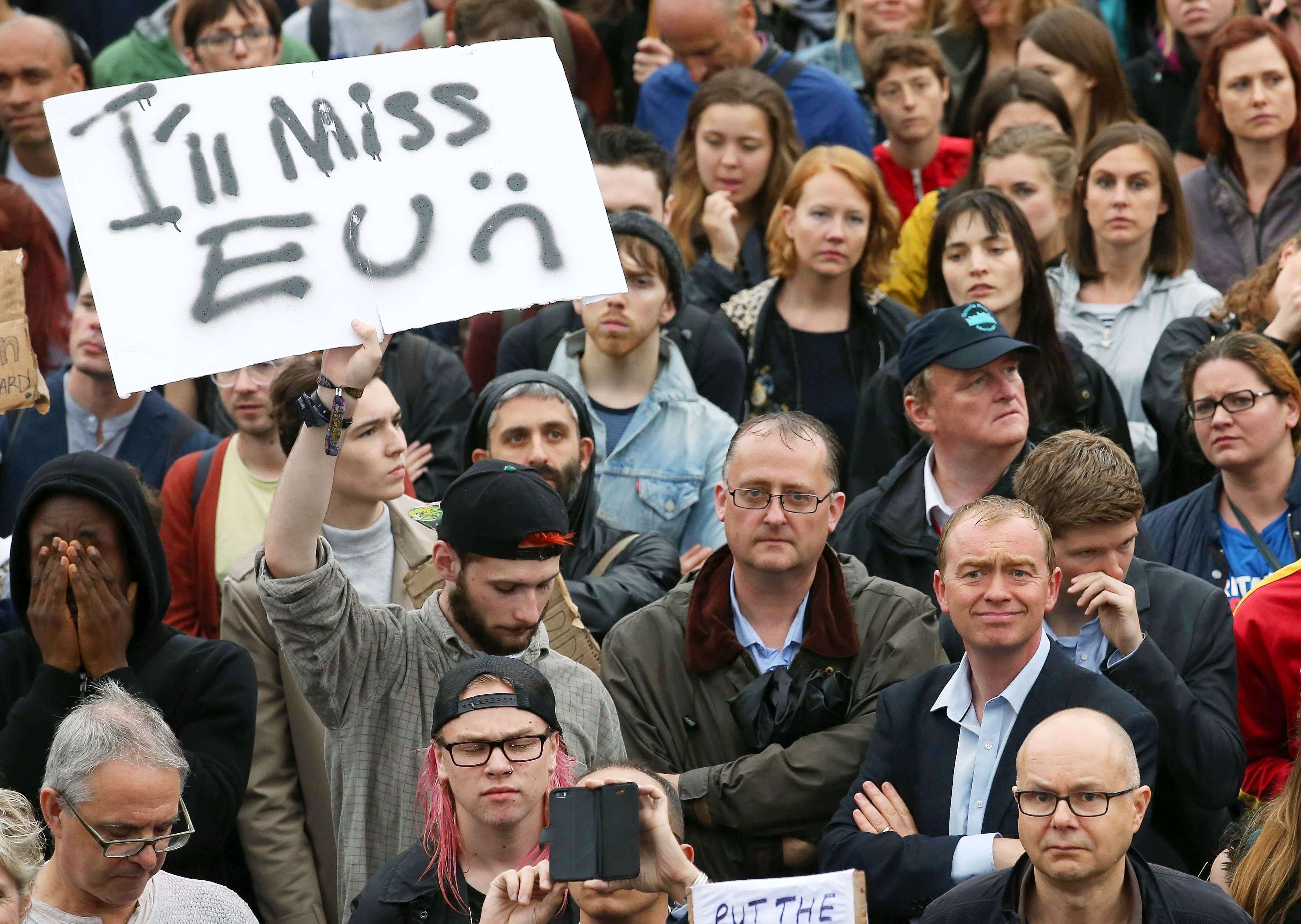 Britain's Liberal Democrats Party leader Tim Farron (below right, blue shirt) joins people at an anti-Brexit protest in Trafalgar Square in central London on June 28, 2016. EU leaders attempted to rescue the European project and Prime Minister David Cameron sought to calm fears over Britain's vote to leave the bloc as ratings agencies downgraded the country. Britain has been pitched into uncertainty by the June 23 referendum result, with Cameron announcing his resignation, the economy facing a string of shocks and Scotland making a fresh threat to break away. / AFP PHOTO / JUSTIN TALLIS