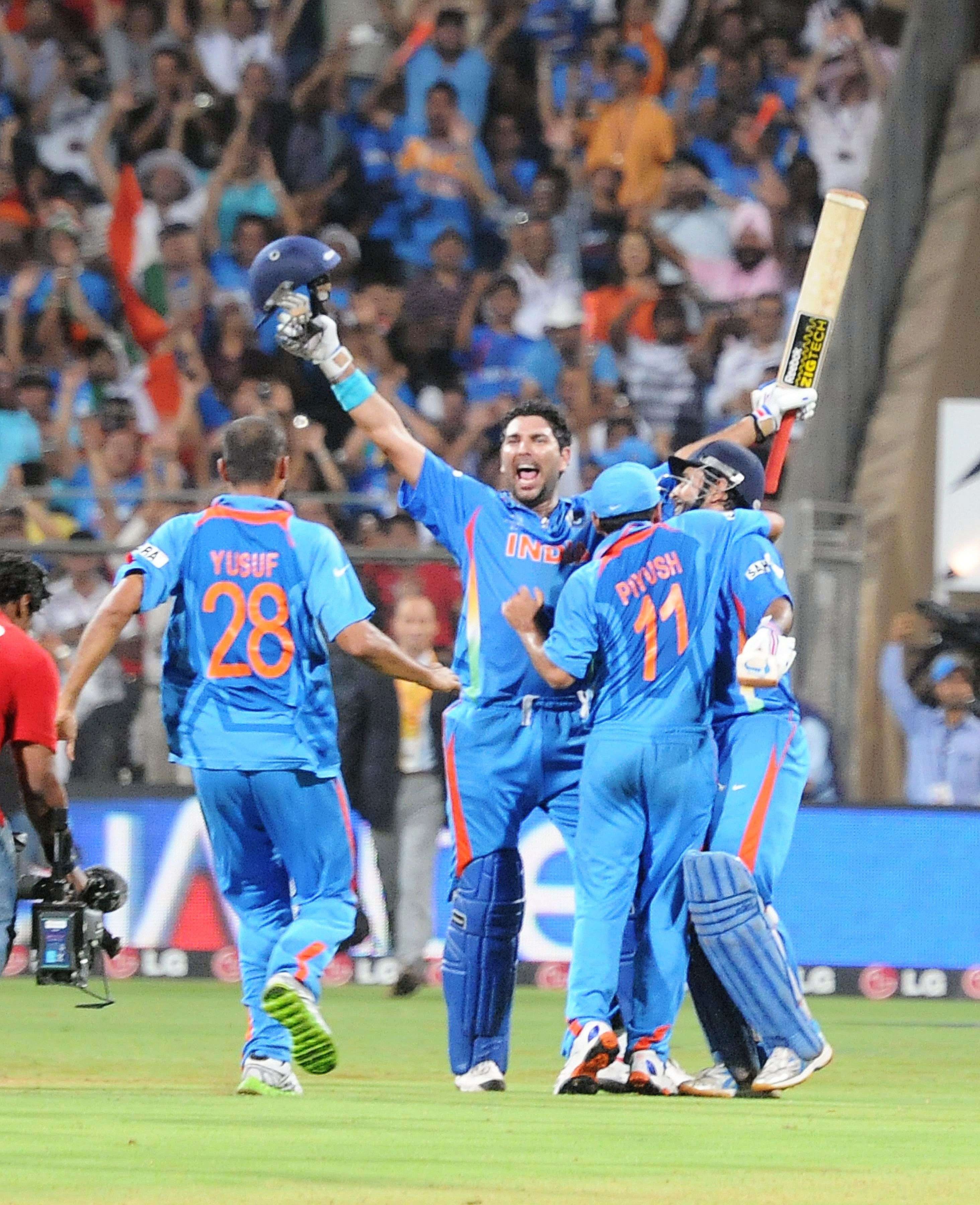 Yuvraj Singh and Mahendra Singh Dhoni celebrate their team's victory over Sri Lanka in the 2011 CWC finals in Mumbai