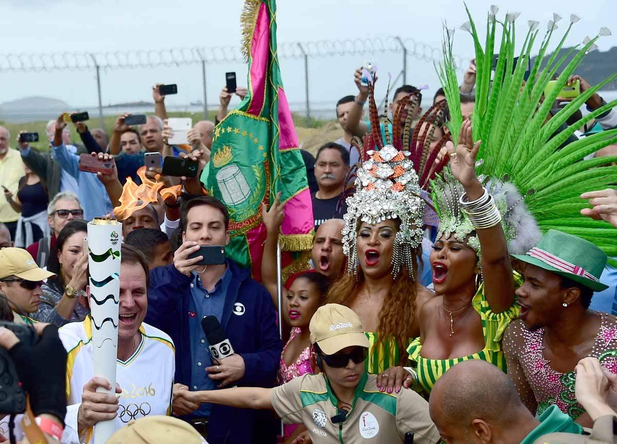 The mayor of Rio Eduardo Paes carries the Olympic torch after it arrived in Rio, Auguest 3, 2016. (AFP / Tasso Marcelo)