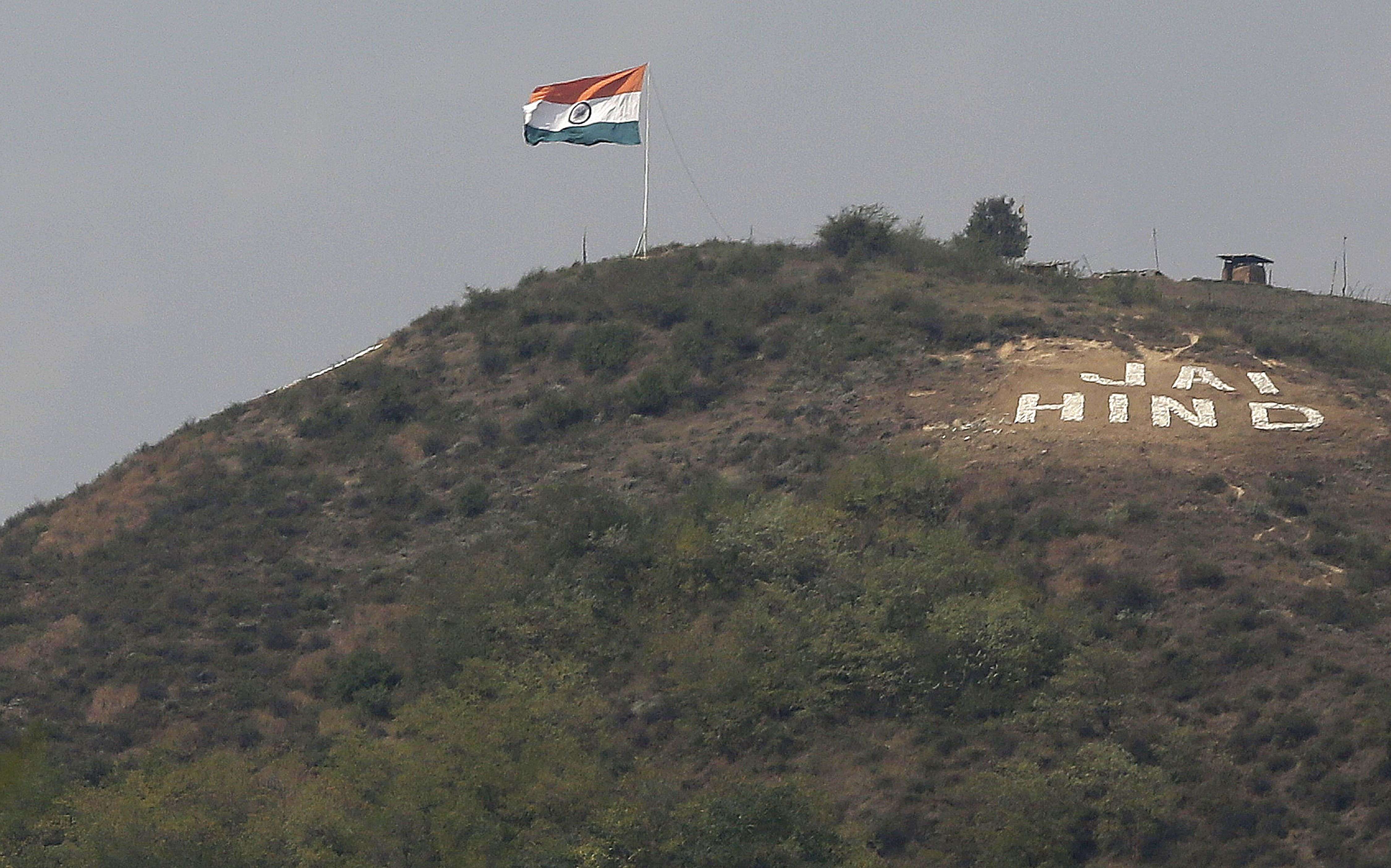 An Indian flag flies on a hill in Uri sector, near the de facto border dividing Kashmir between India and Pakistan, in Indian controlled Kashmir, Wednesday, Sept. 21, 2016. Indian soldiers on Wednesday searched areas near the de facto border where two gunbattles with suspected rebels raged for half a day, the Indian army said. Army spokesman Col. Rajesh Kalia said two groups of militants had infiltrated into the Indian-controlled portion of Kashmir from the Pakistani-held part near Uri region and Nowgam sector. (AP Photo/Mukhtar Khan)