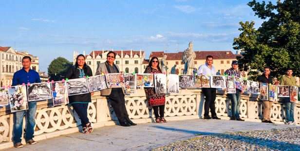 Indians and Bangladeshis hold photographs of Kolkata in the holy city of Padova to celebrate the Sainthood Project