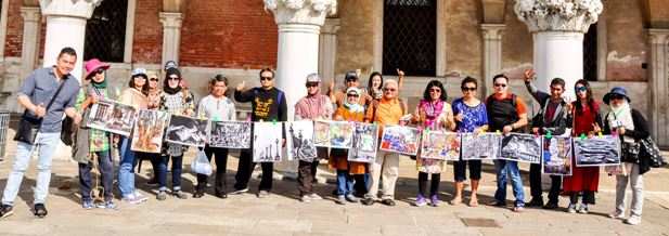 Group of Indonesians hold photographs of Kolkata in Venice to celebrate the Sainthood project - exhibition of 55 photographs of Kolkata on the streets of Italy. 