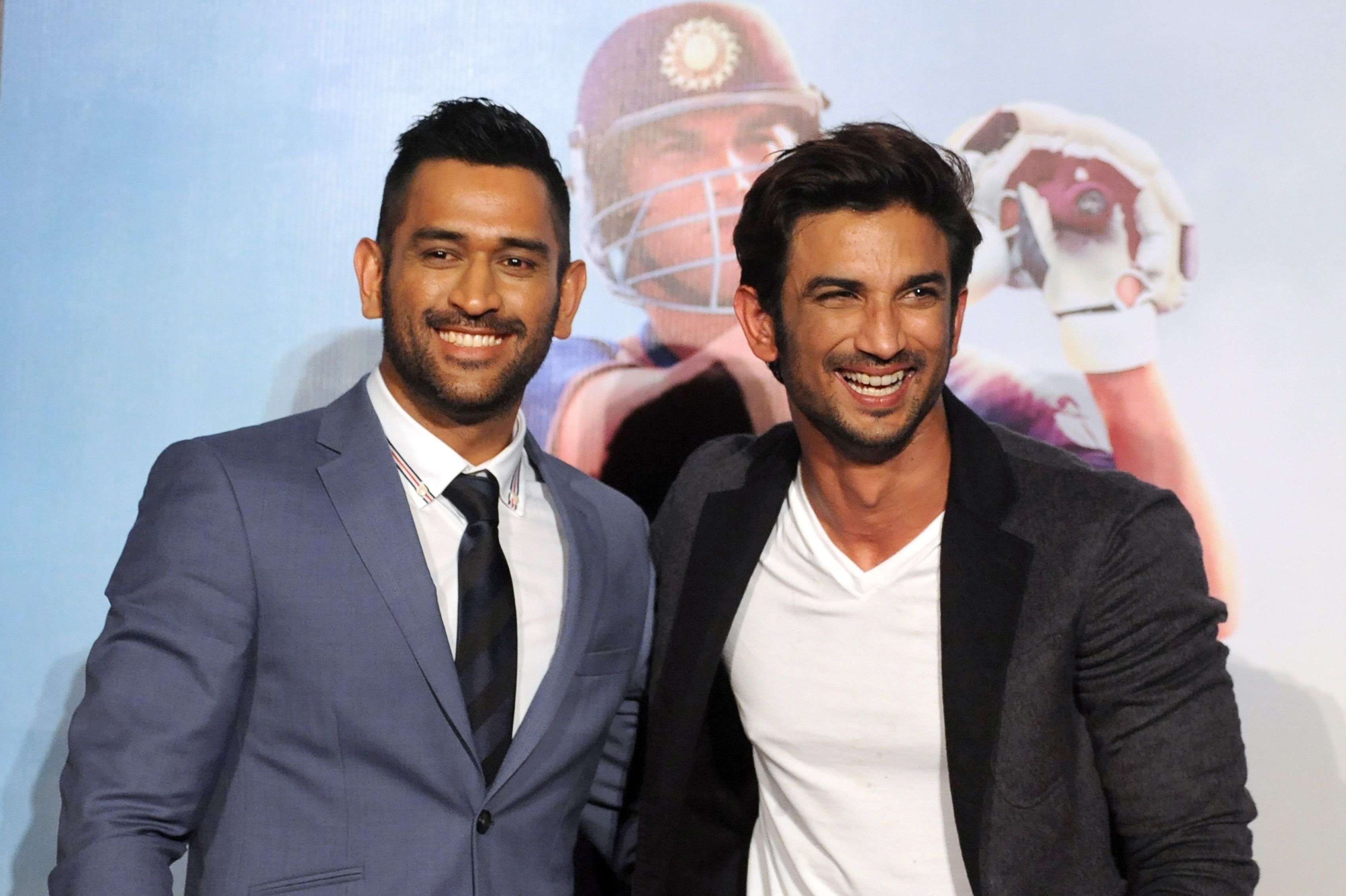 In this photograph taken on August 11, 2016, Indian Bollywood actor Sushant Singh Rajput (R) and Indian cricket captain Mahendra Singh Dhoni pose during the trailer launch in Mumbai of the upcoming biographical film "MS Dhoni: The Untold Story" directed by Neeraj Pandey. "MS Dhoni: The Untold Story", due for release on September 30, charts the rise of India's limited-overs captain from boy to train ticket collector to World Cup glory. / AFP PHOTO / STR / TO GO WITH India-entertainment-film-Bollywood-cricket-Dhoni, FOCUS by Peter Hutchison