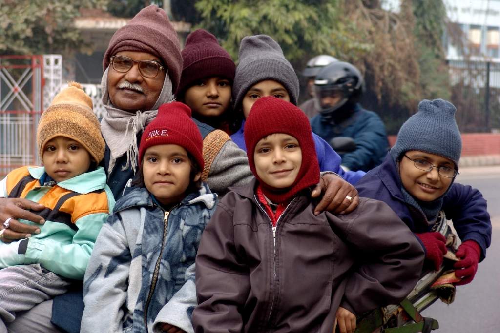 An old man, going on a rickshaw, with his grandchildren in the Ghazipur area on Saturday in Lucknow. The winter chill brought out the monkey caps. TOI Lucknow Photo - By TOI