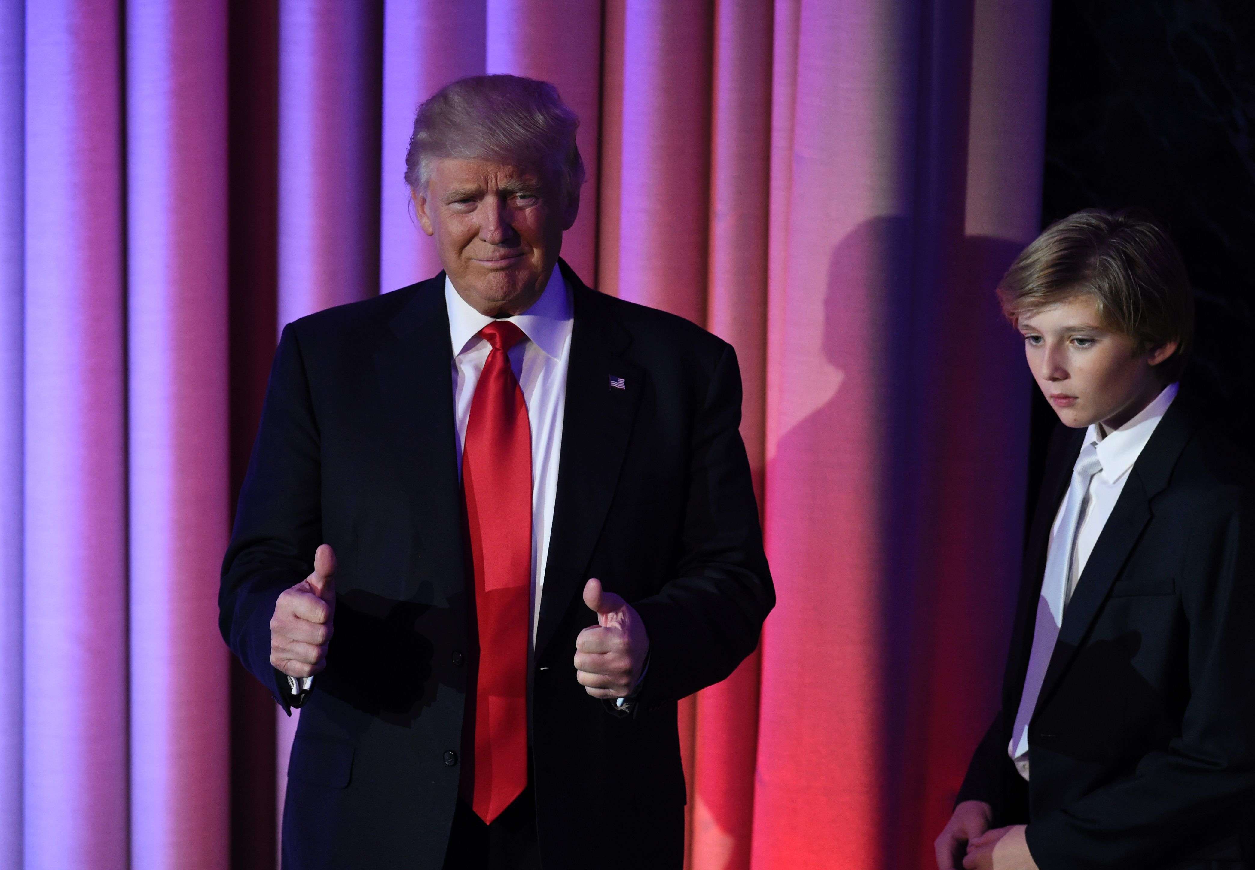 TOPSHOT - US President-elect Donald Trump arrives with his son Baron at the New York Hilton Midtown in New York on November 8, 2016.  Trump stunned America and the world Wednesday, riding a wave of populist resentment to defeat Hillary Clinton in the race to become the 45th president of the United States. / AFP PHOTO / SAUL LOEB