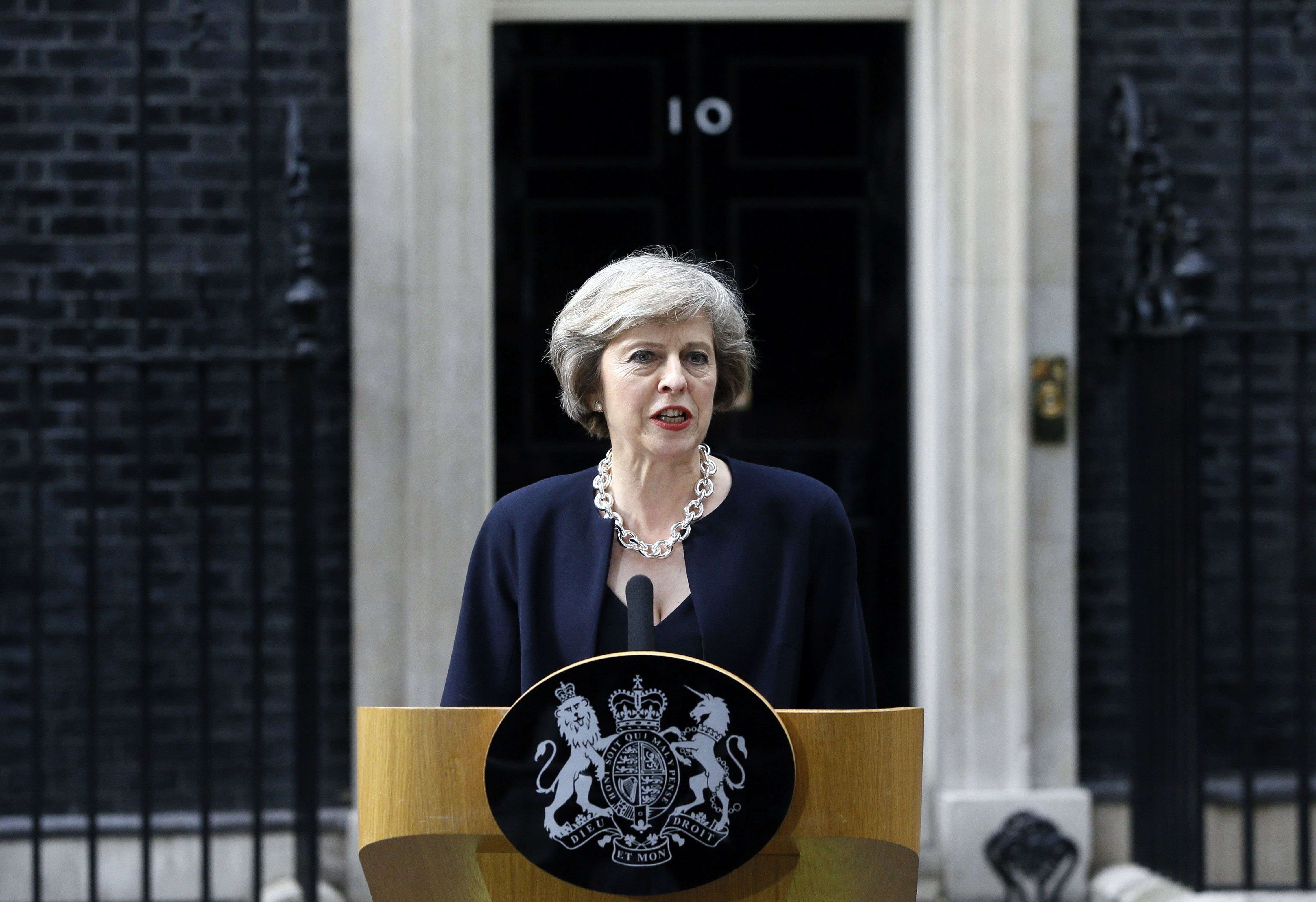 FILE - In this Wednesday July 13, 2016 file photo, new British Prime Minister Theresa May speaks to the media outside her official residence,10 Downing Street in London. Theresa May wanted Britain to stay in the European Union, but the government she unveiled Thursday leaves little doubt that she intends to take it out. The new prime minister has appointed leading euroskeptics - including the unpredictable Boris Johnson and the formidable David Davis - to top international jobs in a Cabinet that sweeps away many of the stalwarts of predecessor David Cameron's administration. (AP Photo/Kirsty Wigglesworth, file)