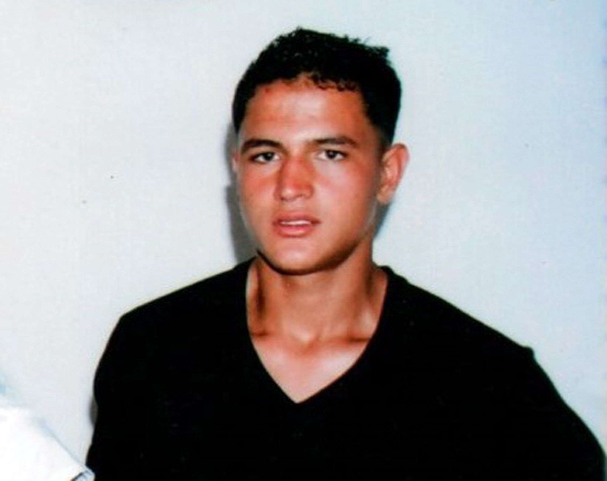 This undated picture provided by Najoua Amri on Thursday, Dec. 22, 2016, shows the fugitive Tunisian suspected in Berlin's deadly Christmas market attack, Anis Amri, posing at his parents' house in Oueslatia, central Tunisia. German authorities issued a wanted notice for Anis Amri on Wednesday and offered a reward of up to 100,000 euros ($104,000) for information leading to the 24-year-old's arrest, warning that he could be "violent and armed." (Courtesy Najoua Amri to AP)