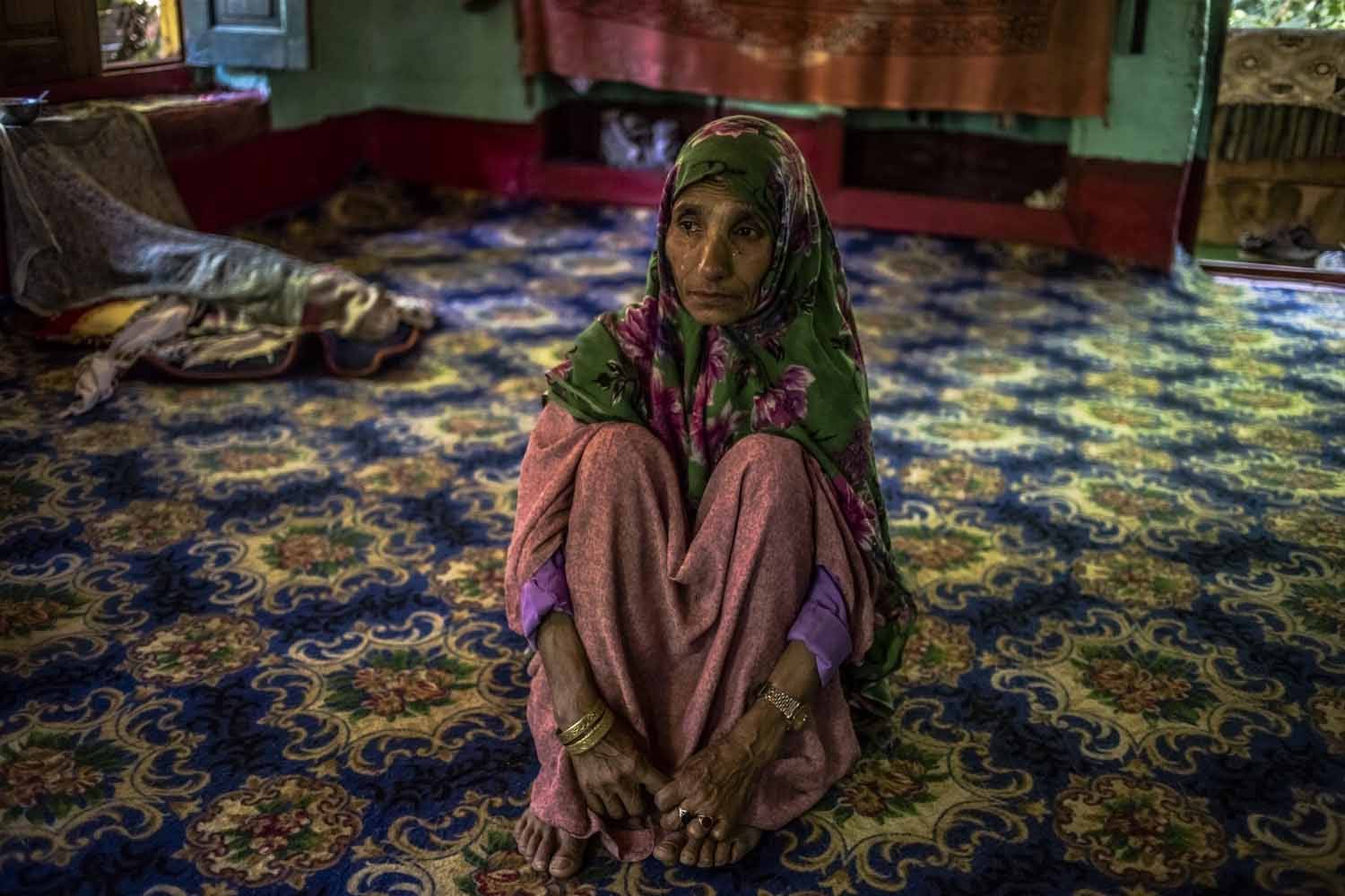 Kashmiri mother Rahma Begum, who is unsure of her age, recounts the disappearance of her son Mir Ali, who went missing in 2003, one year after he got married. For three years after he went missing, Rahma, who lives in Kashmir's Kupwara district, searched for her son, leaving home daily to visit surrounding villages and consult with 'pirs', or faith healers in the district of Sopore and Srinagar who told her they could 'contact' her son. One pir told her her son was near the border with Pakistan; another that Ali had 'appeared' to him and told him he had been abducted by a group of men. Yet another repeatedly asked her to come back the following day, and he would tell her where her son had gone. Villagers told her the search was in vain. 'They told me I had gone mad, that I was mad', she says. She finally stopped looking for Ali after seeing her son in a dream. (AFP / Rebecca Conway)