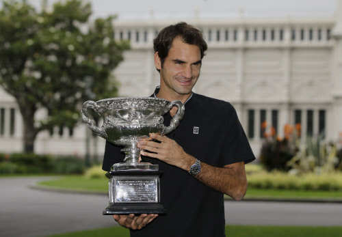 Switzerland's Roger Federer poses for photos with his Australian Open trophy at Carlton Gardens in Melbourne, Australia on Jan. 30, 2017. (AP Photo)