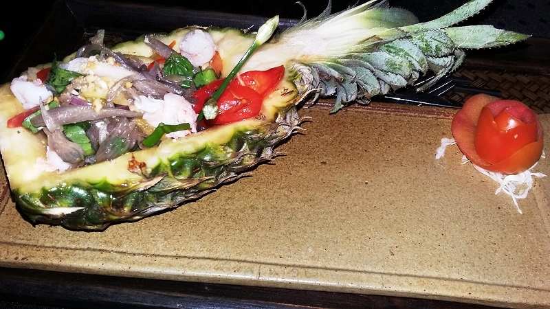 The salad served in a pineapple boat