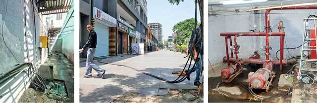 (L to R): Water drips from AC into open wires in close vicinity of gas line; power line enters complex from a tree outside; water collects around heavy duty motor; Photo: Jignesh Vora (L to R): Water drips from AC into open wires in close vicinity of gas line; power line enters complex from a tree outside; water collects around heavy duty motor