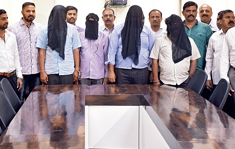 Crime branch officials with the four accused who were held on Thursday during Vakola raid