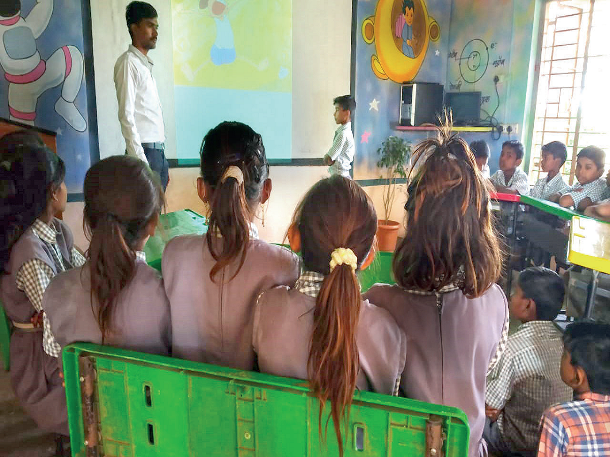 Amit Dudave takes kids through the digital version of stories in Pawari