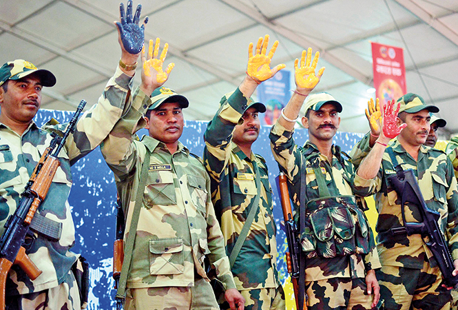Paramilitary personnel participating in the handprint painting record at the Kumbh (BCCL/ Pankaj Singh) Paramilitary personnel participating in the handprint painting record at the Kumbh (BCCL/ Pankaj Singh)