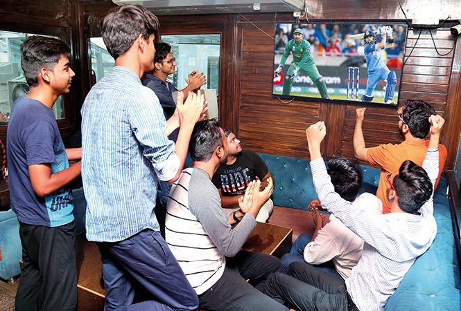 Youngsters enjoying the cricket match at a lounge in the city (BCCL/ Aditya Yadav)