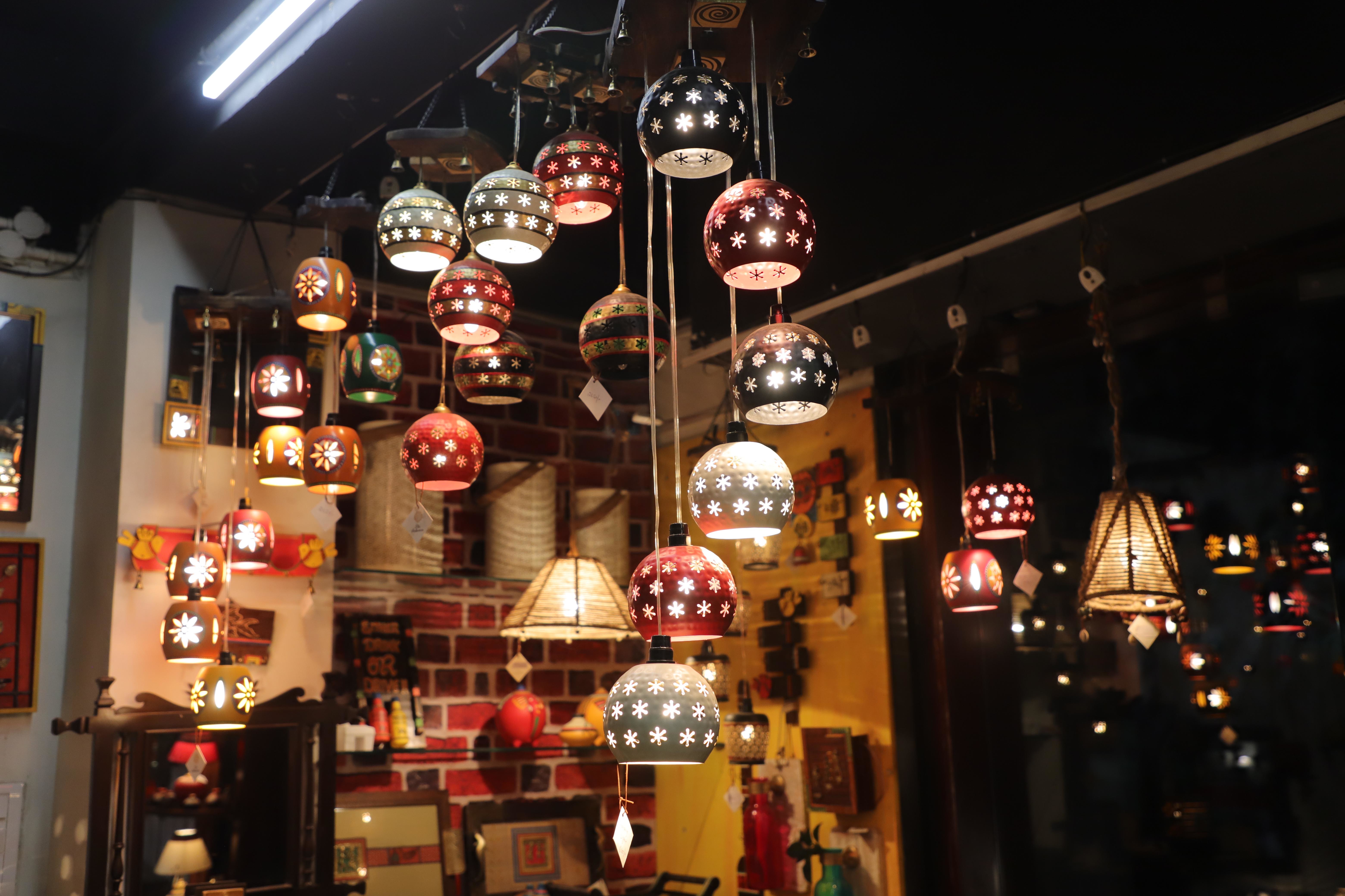 Range of handcrafted and hand-painted metal lights on display