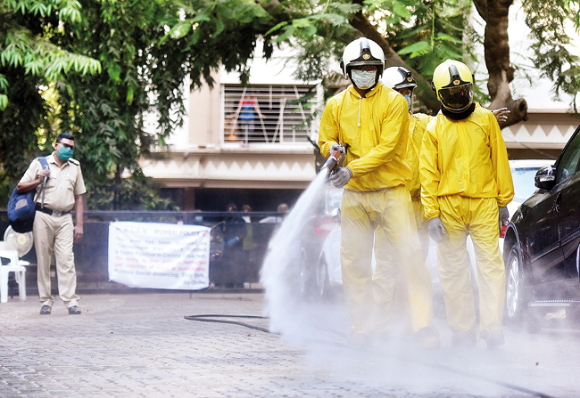 Fire brigade personnel carry out disinfection work in Kandivali following a new case