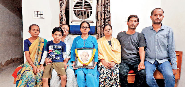 Devrambhai's wife (left) with her three daughters, two sons-in-law and grandson